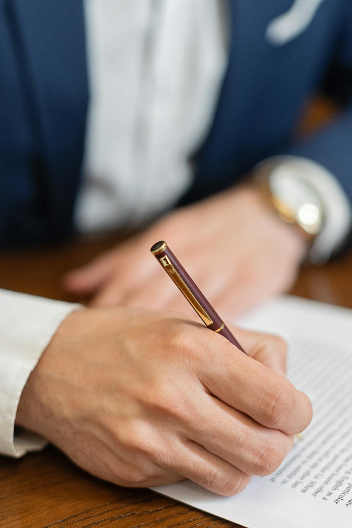 Fountain pen resting on a signed document